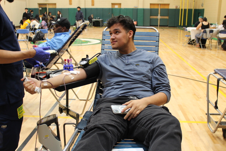 Senior Jonny Romero Majano rolls up a sleeve to donate to the NY Blood Center. Staff and students selflessly contributed to the bi-annual event, which received 51 pints for donation.