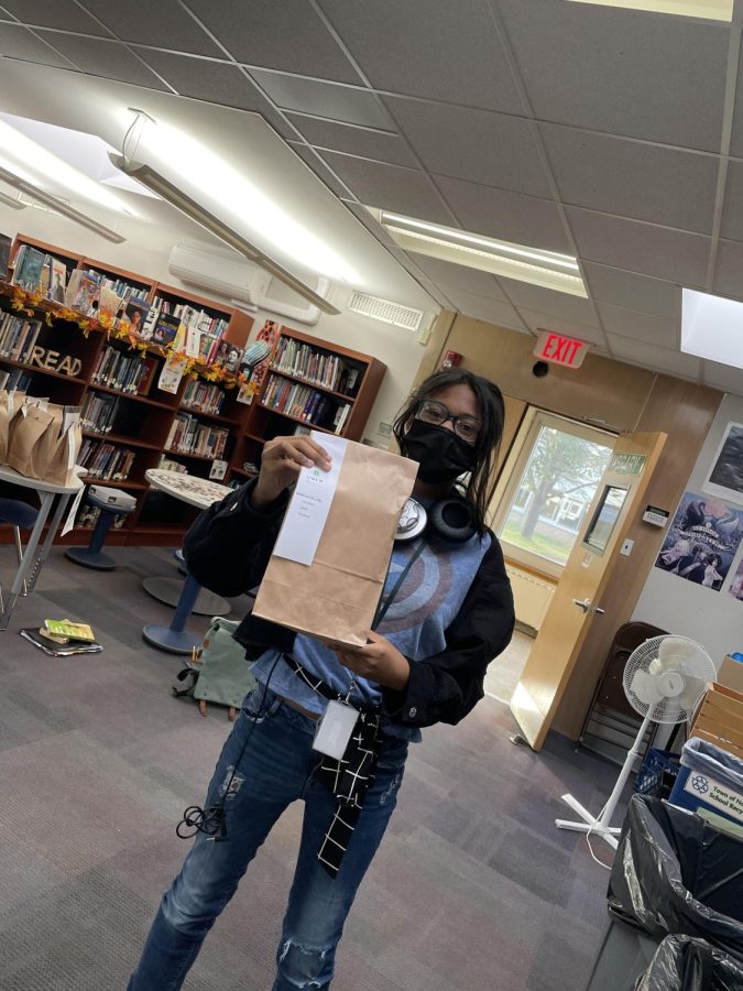 Janae Smith checks out Uber Reads at the Westbury High School library.