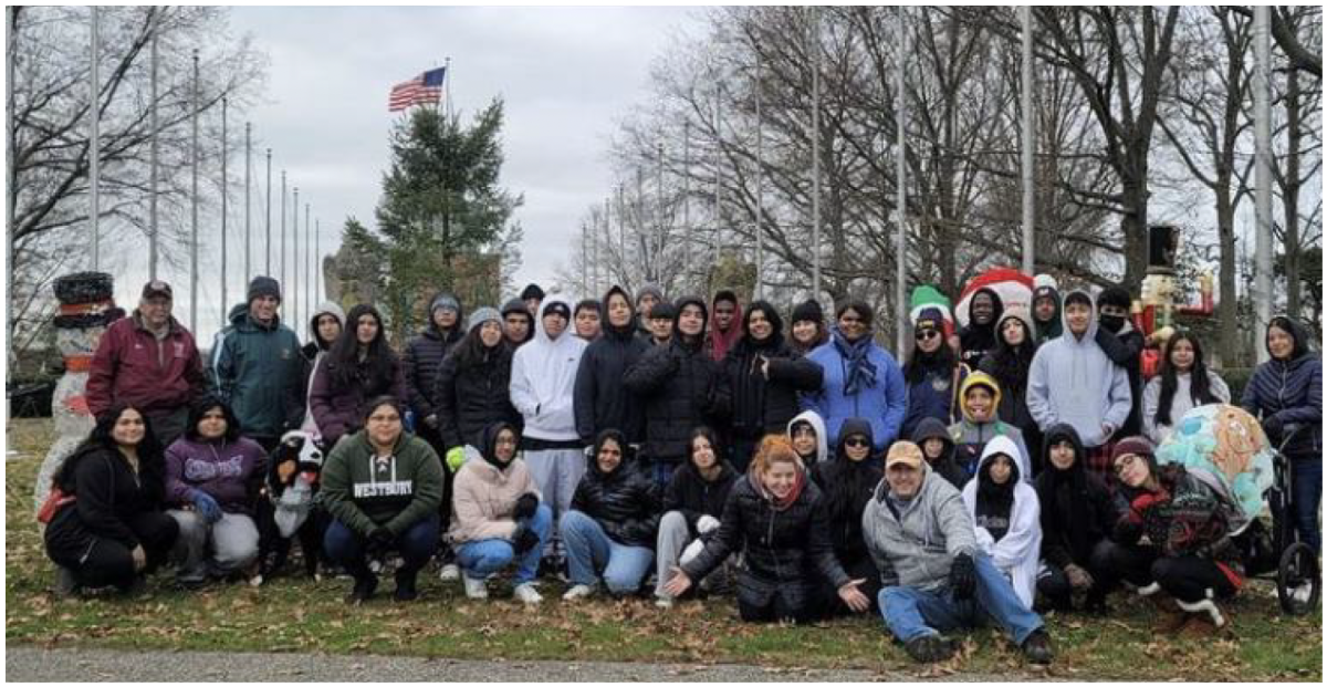 Cadets smile in a group photo after putting up Christmas decorations at the local Veterans Memorial